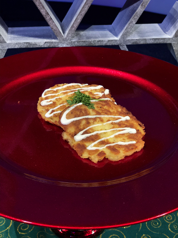 Brown potato latkes on a red plate